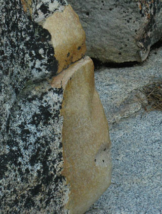 Detail of baby's butt smooth granite remnants on occassionals deposited on flat section of Summit City Creek